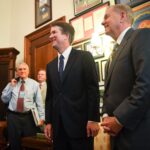 Supreme Court nominee Brett Kavanaugh and Sen. Lindsey Graham (R-SC), right, pose for the media in Graham's Russell Senate office before meeting on Capitol Hill in 2018. Former Sen. Jon Kyl (R-AZ), left, was escorting the nominee around Capitol Hill.